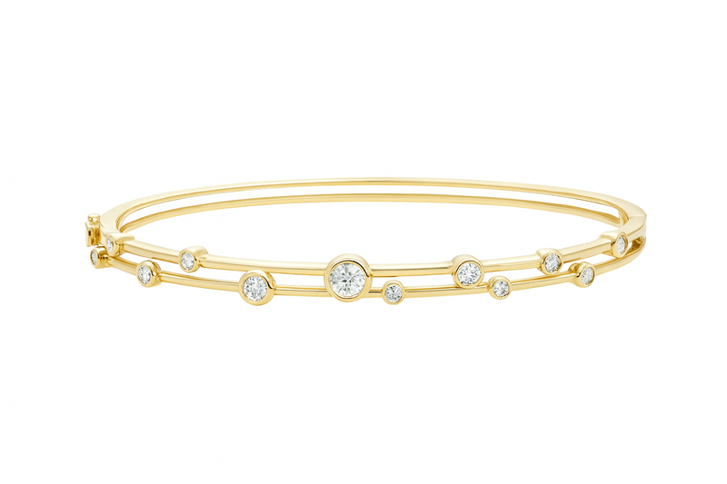 Gold bracelet with small diamonds on a white background