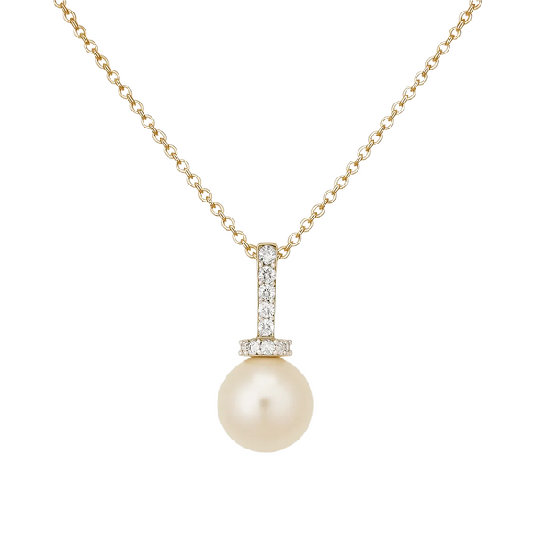 Pearl necklace with gold chain and diamond pendant on a light beige background