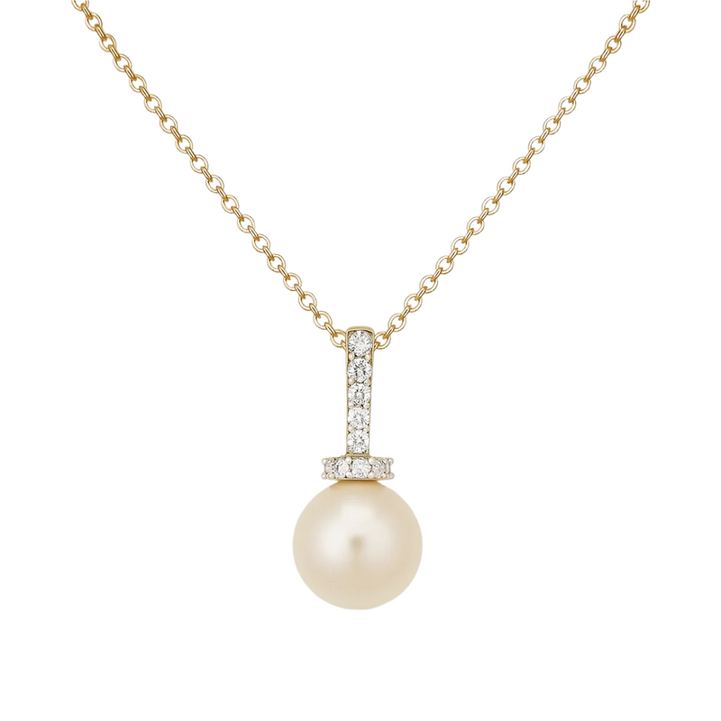 Pearl necklace with gold chain and diamond pendant on a light beige background